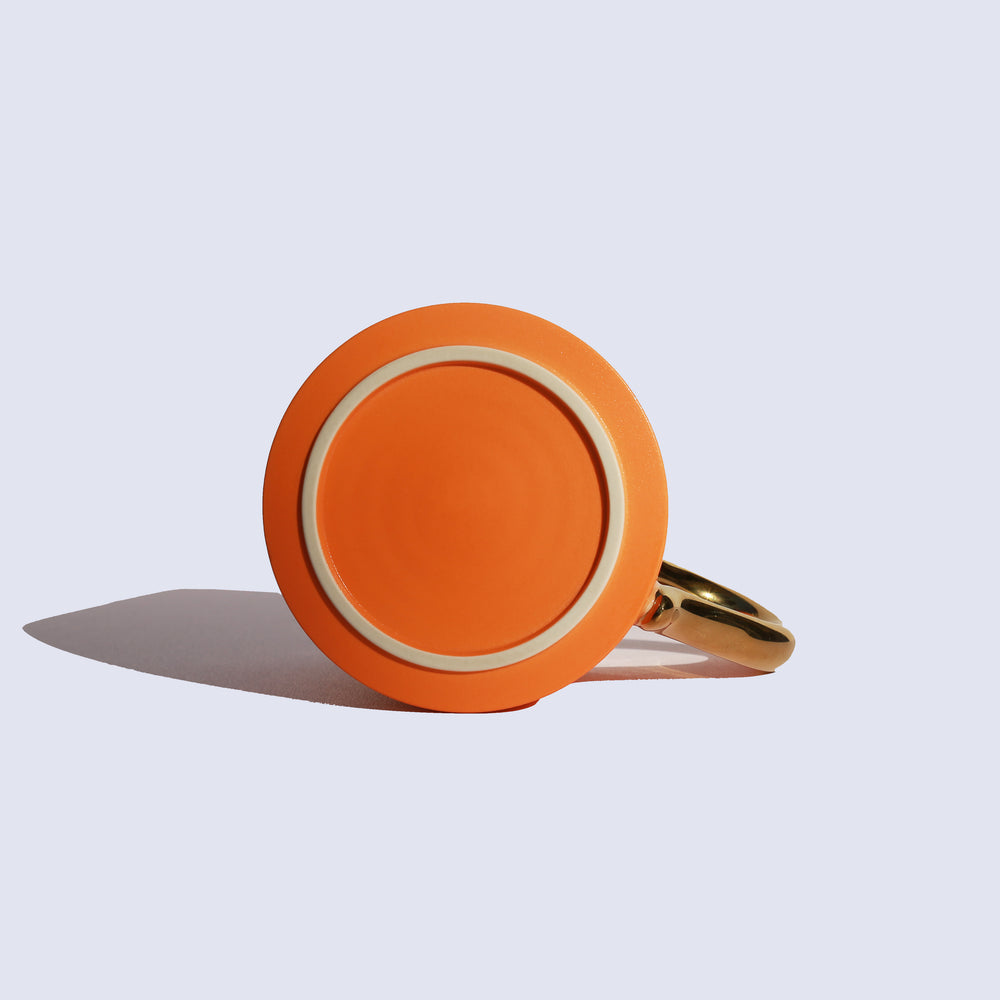 
                  
                    Orange Coffee Mug with Gold Handle
                  
                