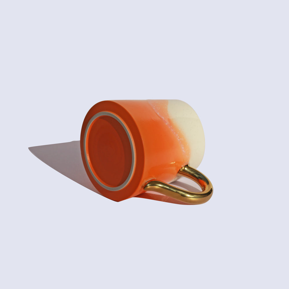 
                  
                    Orange Coffee Mug with Gold Handle
                  
                